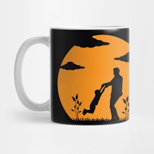 Father and Son Embracing Against the Sunset Mug